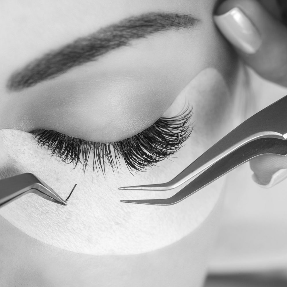 Eyelash Extension Procedure. Woman Eye with Long Eyelashes. Lashes. Close up, macro, selective focus