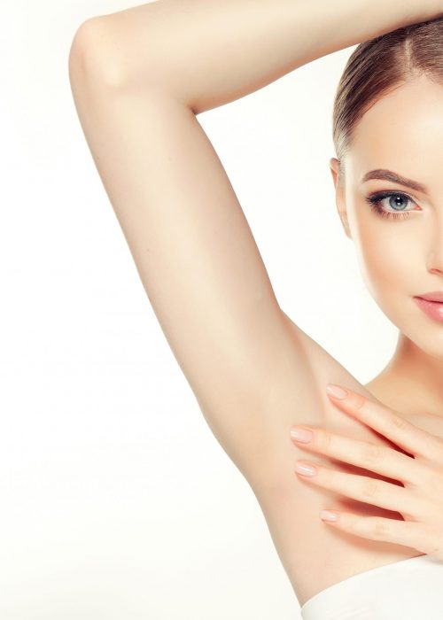 Armpit epilation, lacer hair removal. Young woman holding her arms up and showing clean underarms, depilation  smooth clear skin .Beauty portrait.